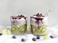 Två glas med chiapudding, kiwi och blåbär. En hälsosam frukost med nyttiga semillas de chia.
