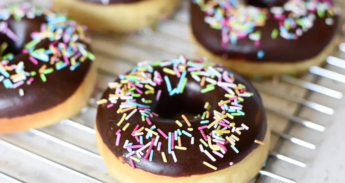 Färska munkar med chokladglasyr och färgglatt strössel. Perfekt för att inspireras av nya recetas de donas.