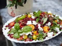 En färgstark sallad med granatäpple, tomater, fetaost och basilika. Perfekt för att visa para qué sirve la ensalada – en hälsosam och god måltid!