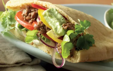 En smakrik pitabrödssmörgås fylld med köttfärs, grönsaker och en krämig sås. Perfekt för snabba och goda **recetas con pan arabe**.