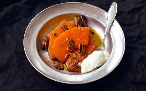 Söta, honungsglaserade pumpaskivor med pekannötter och en klick grädde. En härlig ayote en miel-dessert.