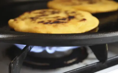 Pupusas de queso con loroco steker på en gaspis.