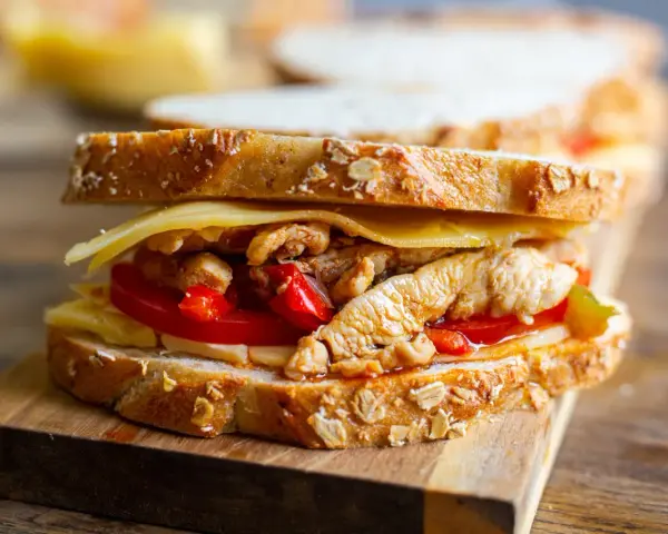 En saftig sandwich med pulled chicken, ost och tomat på grovt bröd. Perfekt för en snabb lunch!